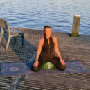 A female meditating sitting on meditation cushion zafu and a cork yoga mat Cosmic Harmony Cork Yoga Mat cork yoga mat
