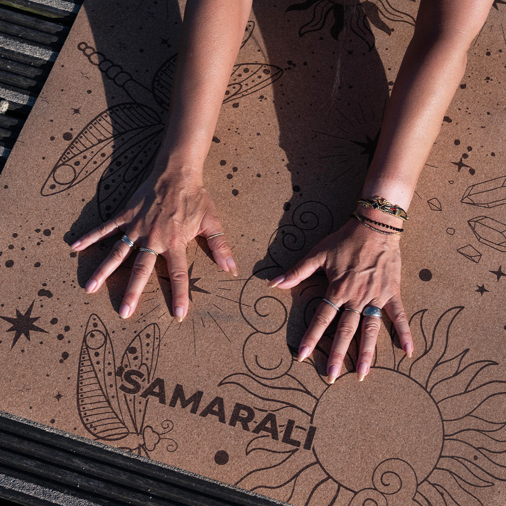 a female exercising on teh cork yoga mat Cosmic Harmony Cork Yoga Mat cork yoga mat
