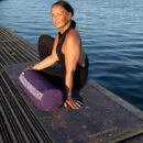a female exercising with yoga bolster Cosmic Harmony Cork Yoga Mat cork yoga mat