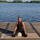 a female meditating on the cork yoga mat and the round meditation cushion Cosmic Harmony Cork Yoga Mat cork yoga mat